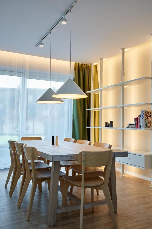 a dining room with a wooden table and chairs at Tatra Green in Veľká Lomnica