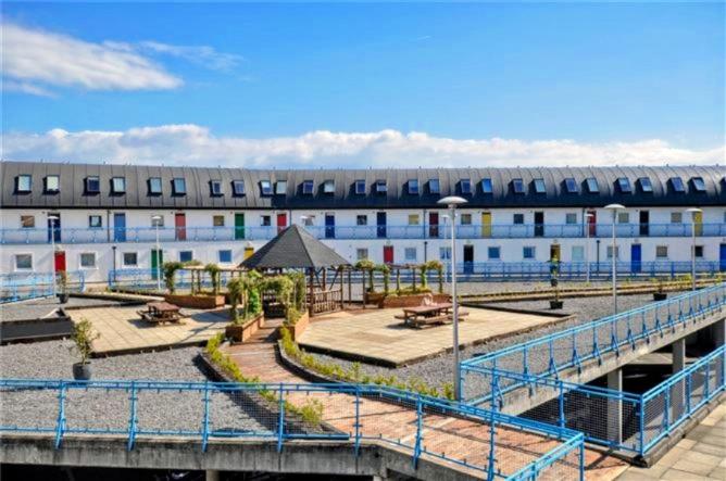 un grande edificio con parco giochi di fronte di Private Double Bedroom in front of the Galway Port - Guest House a Galway
