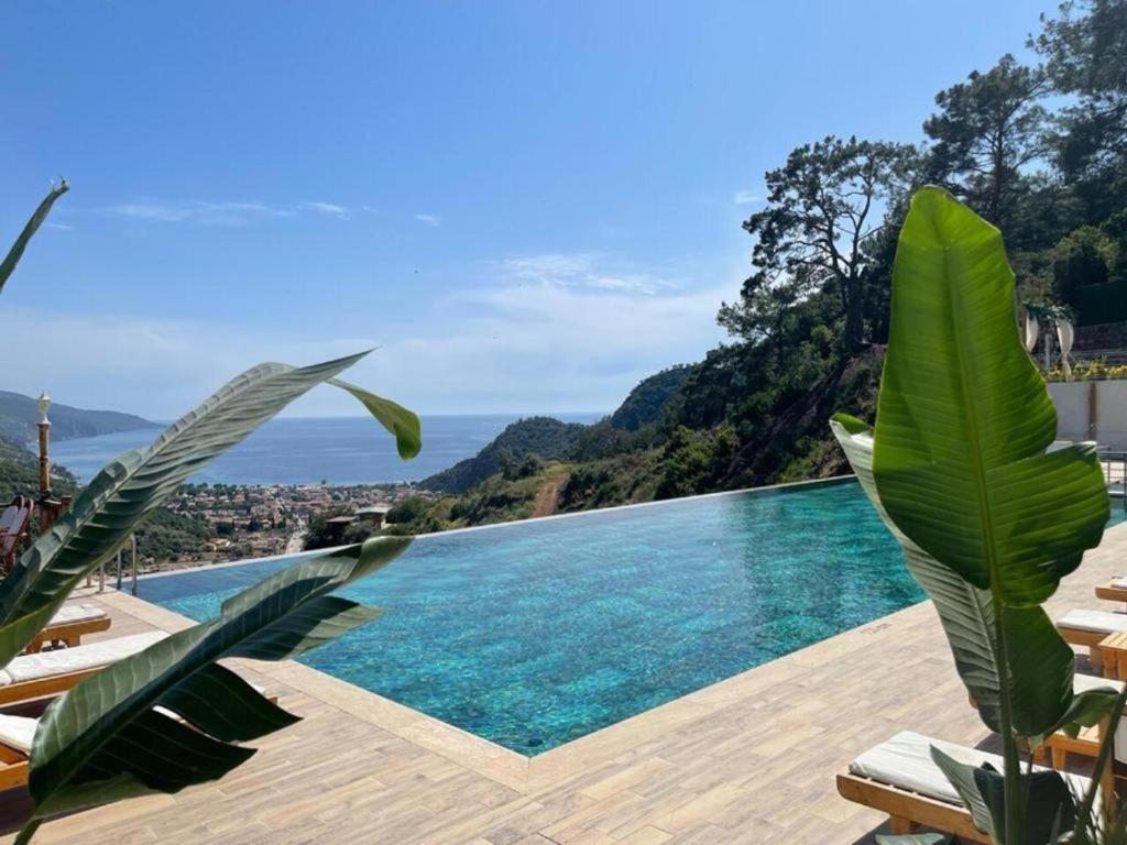 a swimming pool with a view of the ocean at Ölüdeniz Manzara Non Alcoholic Family Hotel in Oludeniz