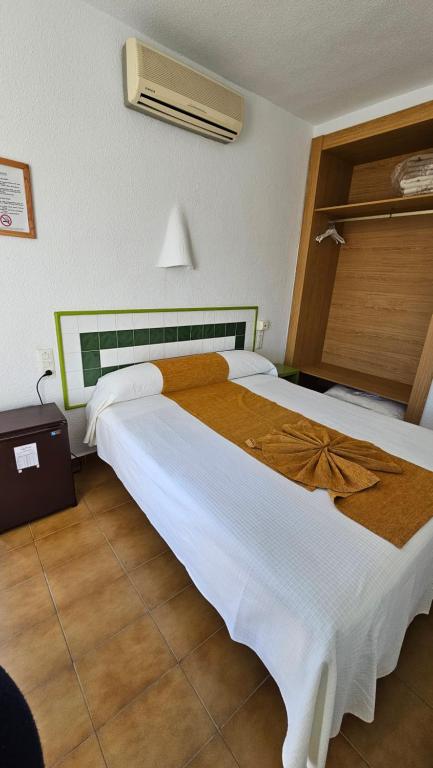 Postel nebo postele na pokoji v ubytování Hotel El Puntazo I