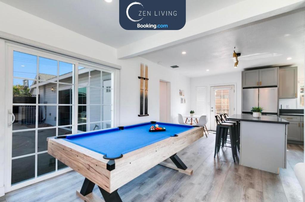 a pool table in a room with a kitchen at Modern Home - Family Fun Hub - Getaway - Billiards By Zen Living Short Term Rental in Glendora