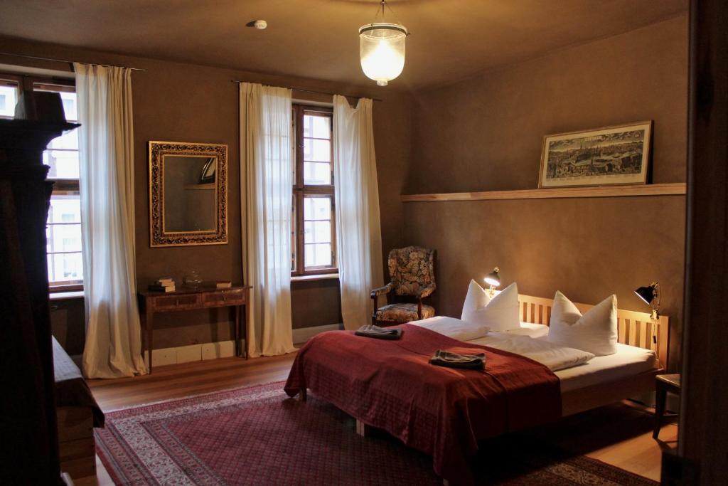 a bedroom with a bed with a red blanket at Altes Kommandeurhaus in Werben an der Elbe in Werben