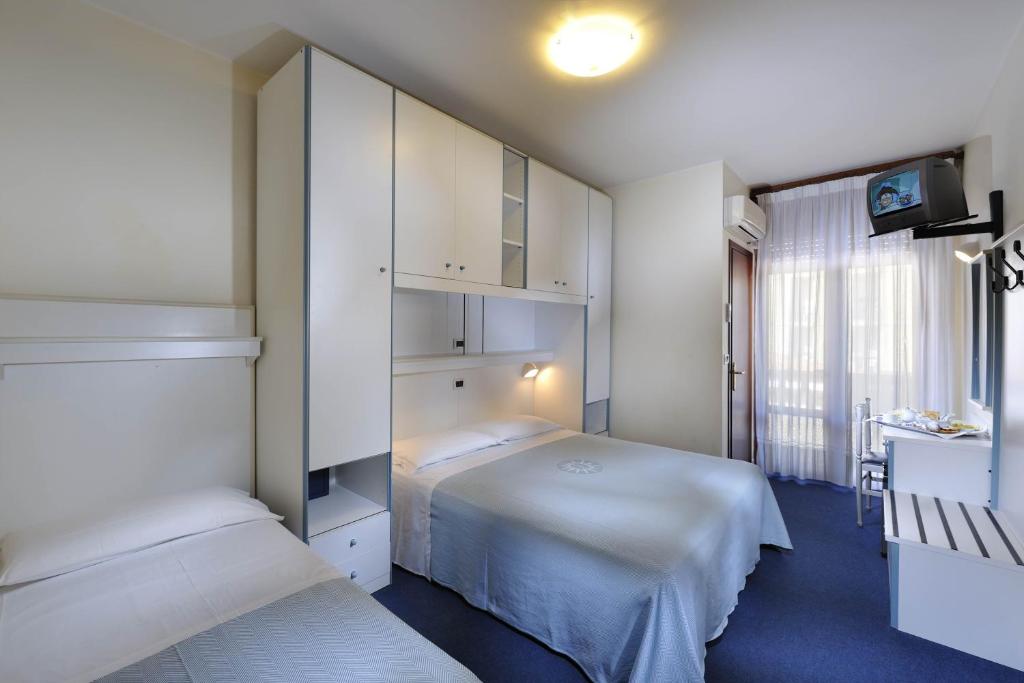 Postel nebo postele na pokoji v ubytování Hotel Danieli