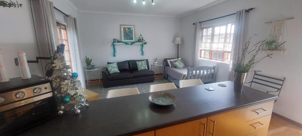 a kitchen and living room with a christmas tree at Grey-door cottage Number1 in Glendinningvale