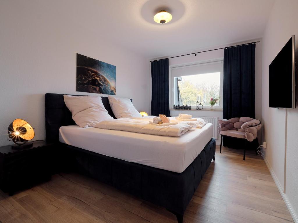 ein Schlafzimmer mit einem großen Bett und einem Fenster in der Unterkunft Waterfront, idyllische Ferien direkt am Wasser mit Blick über die Flensburger Förde in Harrislee