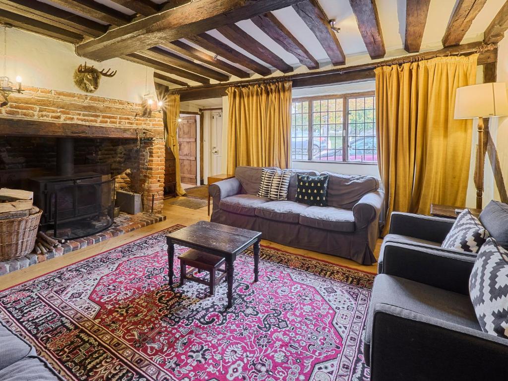a living room with a couch and a fireplace at Host & Stay - The Bell House in Canterbury