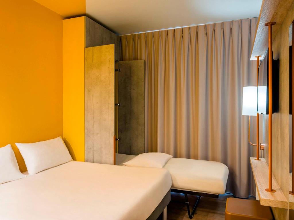 Postel nebo postele na pokoji v ubytování ibis budget Epinal