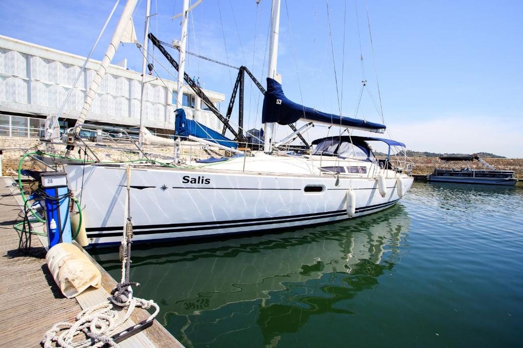 a white sailboat docked at a dock in the water at Salis - Jeanneau 39i in Lisbon