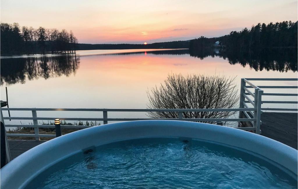 a bath tub with a view of a lake at Lovely Home In Hjltevad With House Sea View in Hjältevad