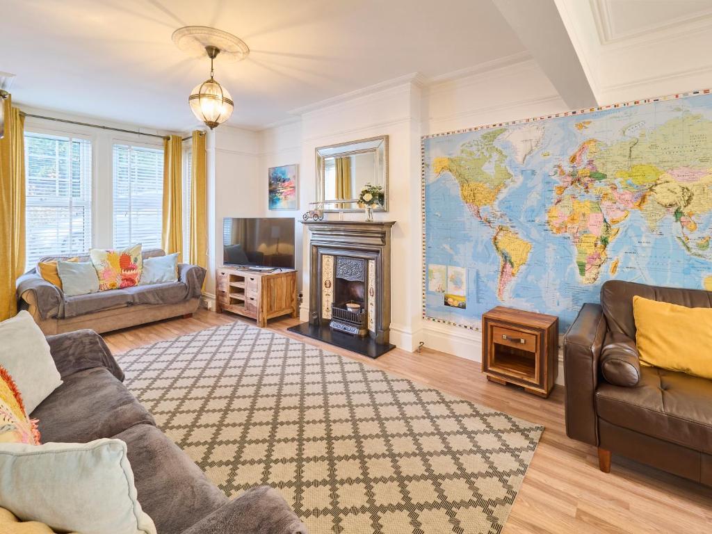 a living room with a map of the world on the wall at Host & Stay - Grosvenor House in Margate