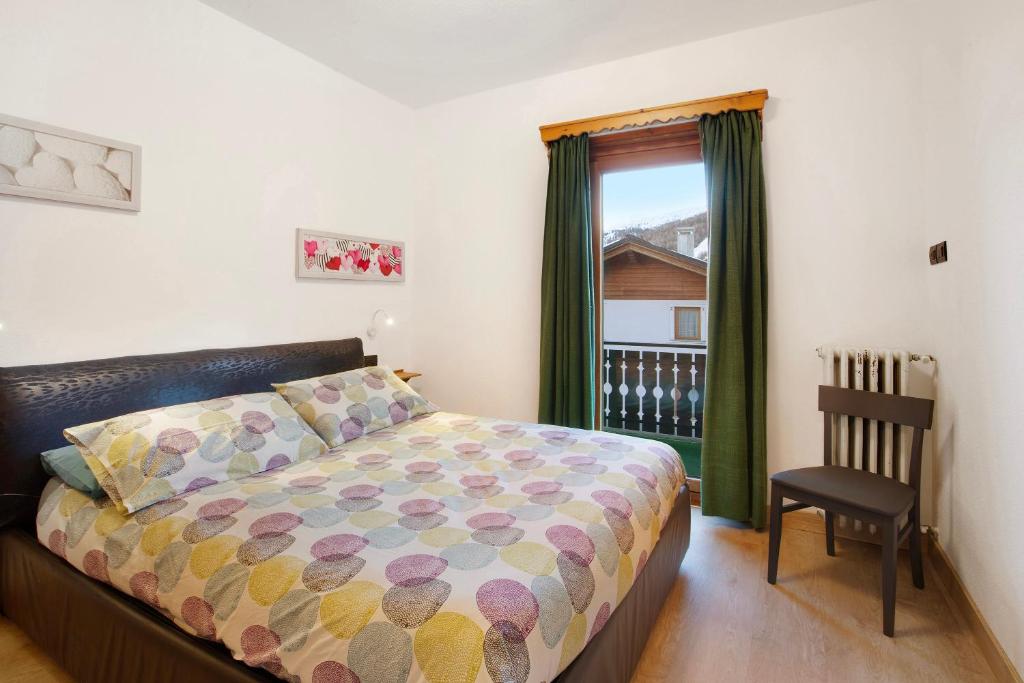 Ένα ή περισσότερα κρεβάτια σε δωμάτιο στο Appartamento Arlecchino Livigno