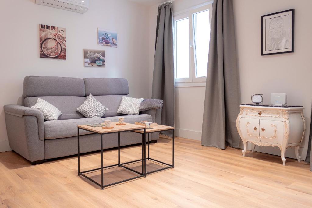 a living room with a couch and a table at Zenete Terral Málaga in Málaga