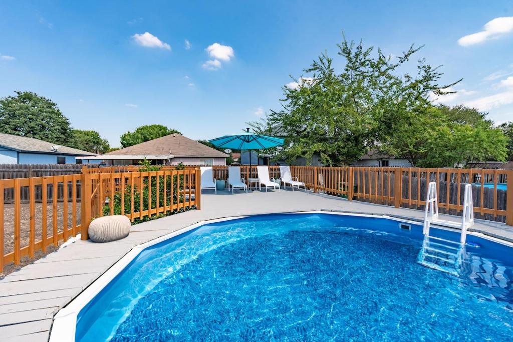 a swimming pool on a deck with a wooden fence at Luxury 5br House With Pool By Seaworld & Lackland in San Antonio