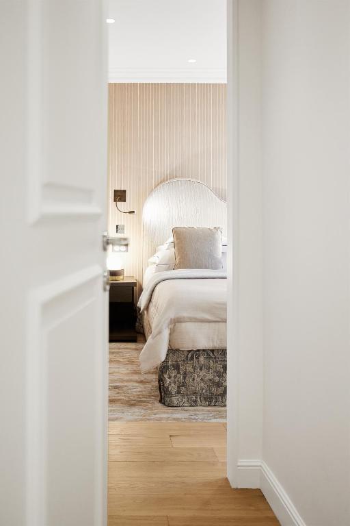 a bedroom with a bed with a white bedspread at Grand Hôtel Du Palais Royal in Paris