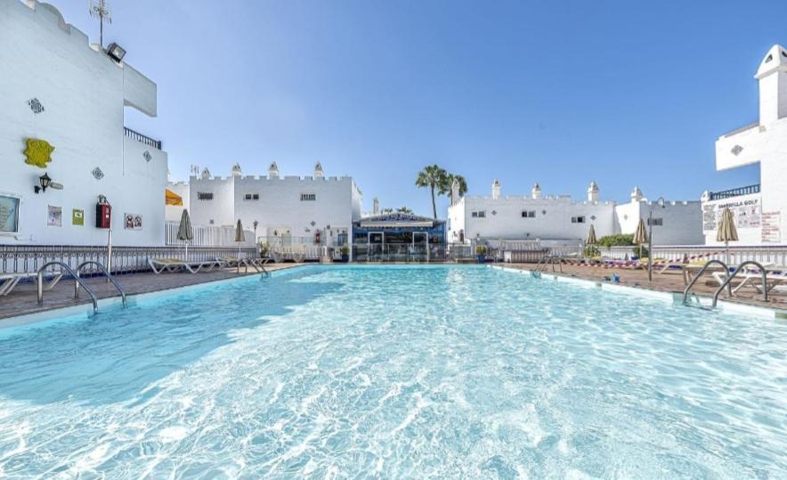 a large swimming pool in front of a building at Bungalow del sol in Playa del Ingles