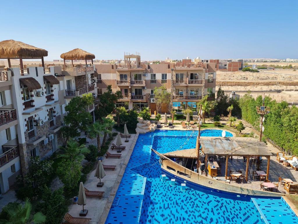 an aerial view of a resort with a boat in a pool at Jungle sweet Home Compound in Hurghada