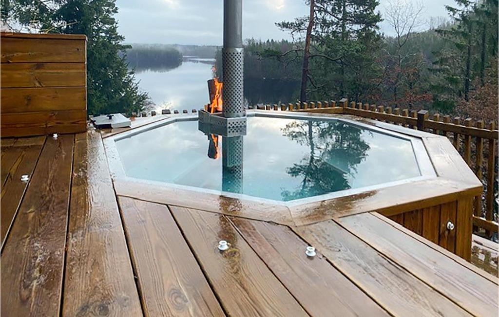 a plunge pool on a deck with a view of a lake at 3 Bedroom Gorgeous Home In Ullared in Ullared
