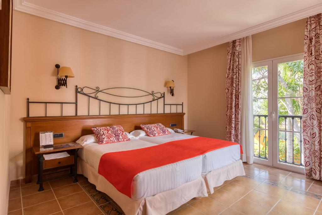 a bedroom with a large bed and a window at Hotel Cordial Mogán Playa in Puerto de Mogán
