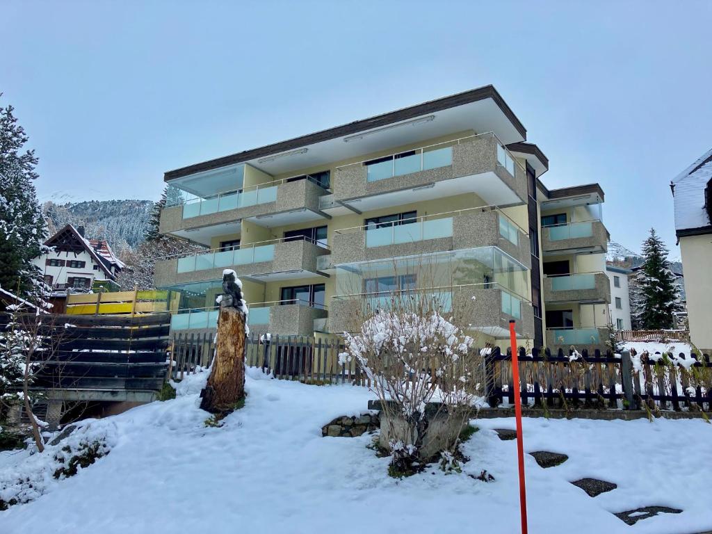 a building with snow in front of it at Valbella in Davos