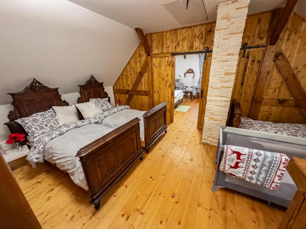 a bedroom with a bed in a room with wooden walls at Roubenka Bruno in Karlovy Vary