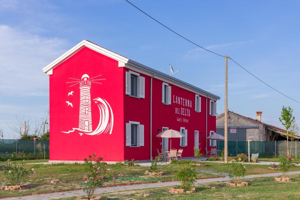a red building with a lobster painted on it at LANTERNA DEL DELTA Guest House in Porto Tolle