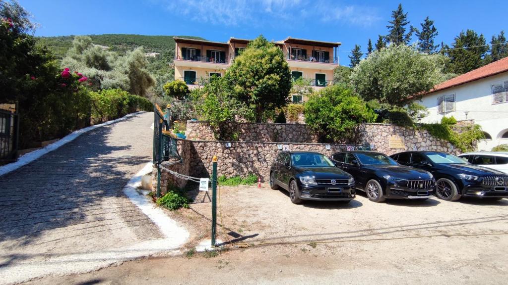 a group of cars parked in front of a building at Captain's House in Sivota