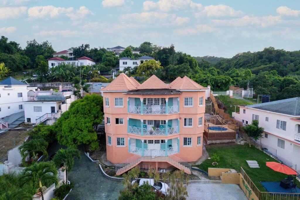 an aerial view of a large pink house at Belle air Seaview 1 BDRM -2 Queen in Runaway Bay