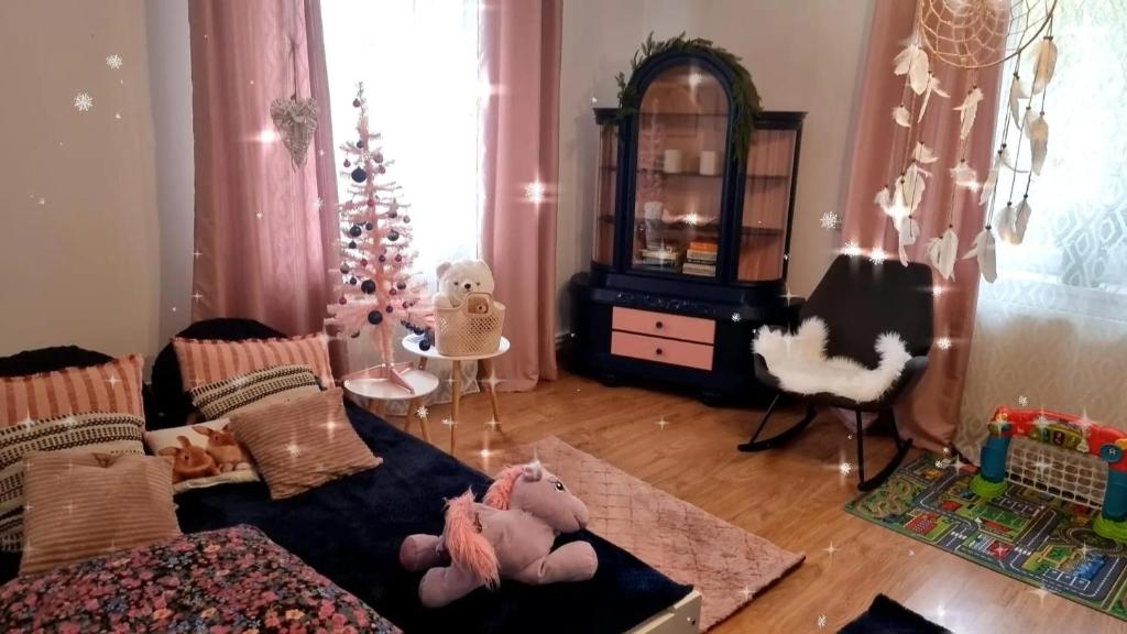 a living room with a couch and a christmas tree at Dom pod Jabłonką in Tomaszów Lubelski