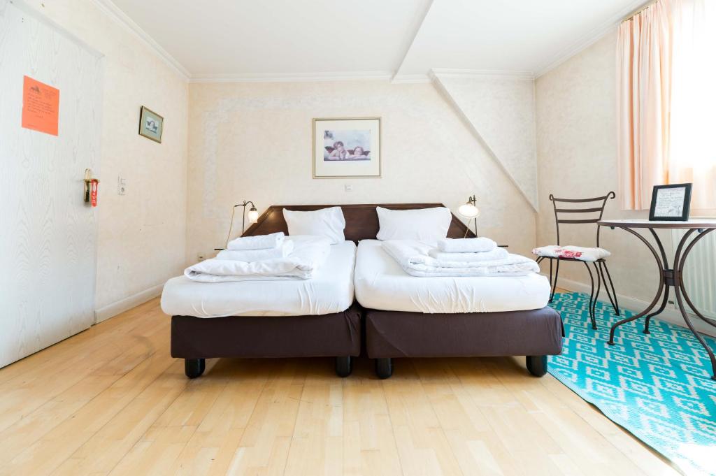 Postel nebo postele na pokoji v ubytování Hotel Leone d´Oro