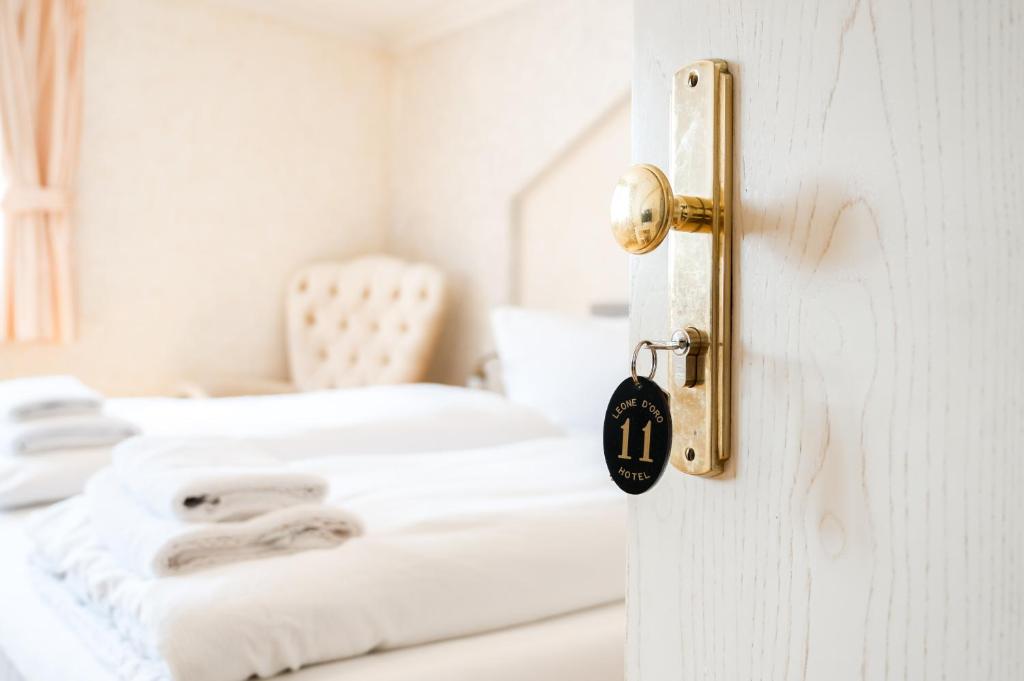 Postel nebo postele na pokoji v ubytování Hotel Leone d´Oro