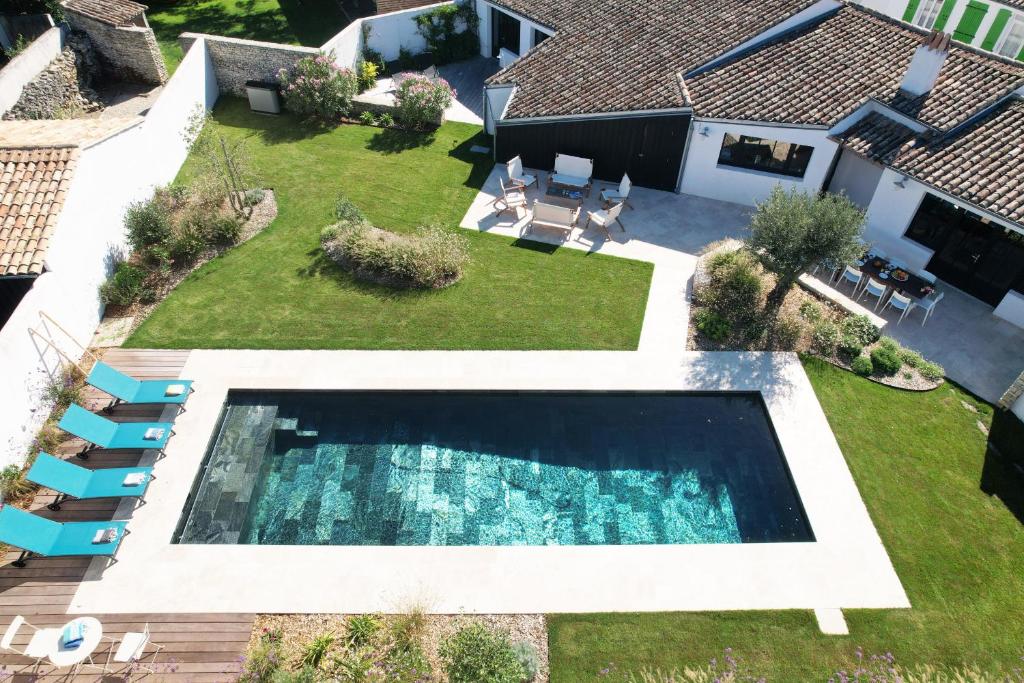 einen Blick über einen Hinterhof mit Pool in der Unterkunft Villa La Saliere in Saint-Clément-des-Baleines