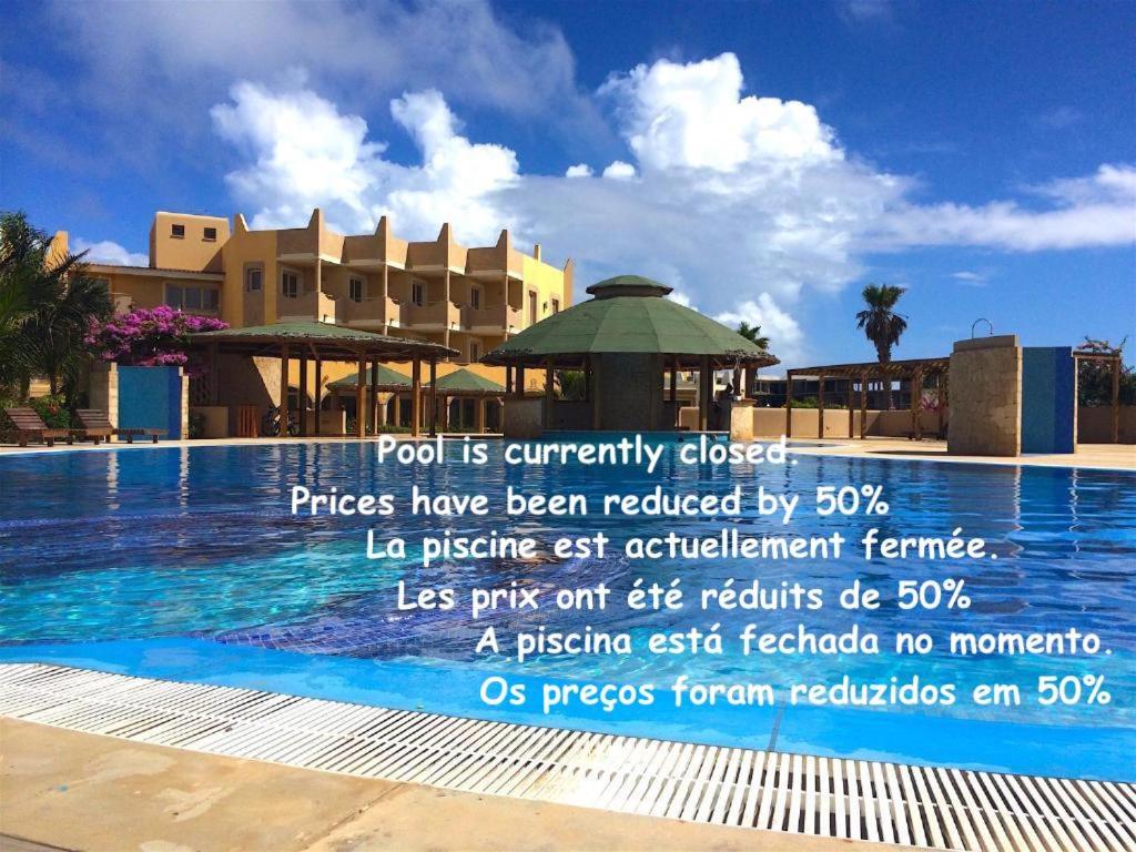 a sign by the swimming pool at a resort at Apartment | in Tropical Resort | pool | close to beach in Santa Maria
