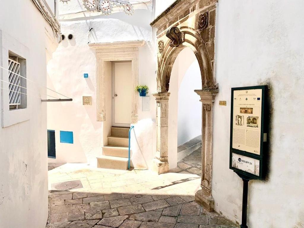 an entrance to a white building with an archway at Le Marangi Getaway Suite in Martina Franca