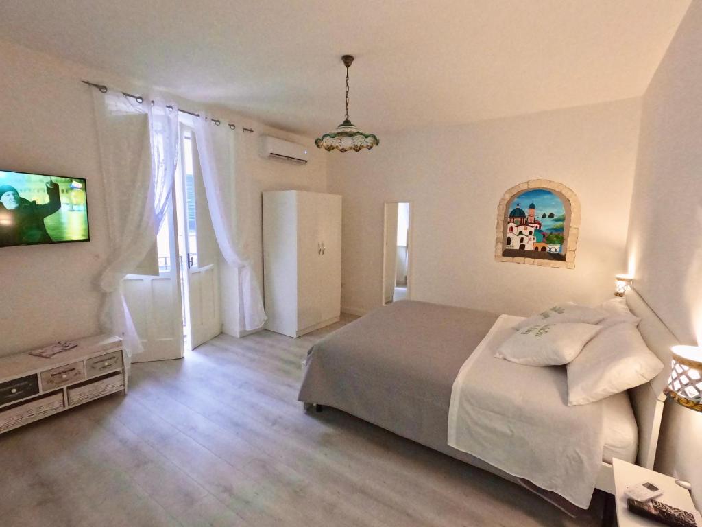 a bedroom with a bed and a television in it at B&B Due Su Due Holiday in Vietri sul Mare