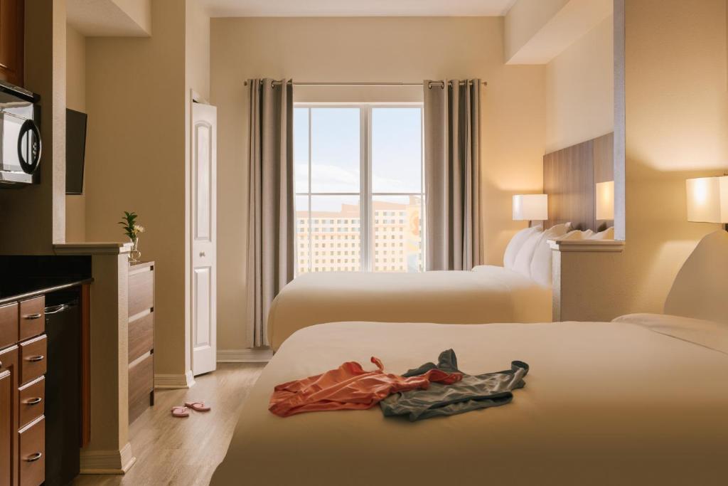 a hotel room with two beds and a window at Sonder at The Point in Orlando