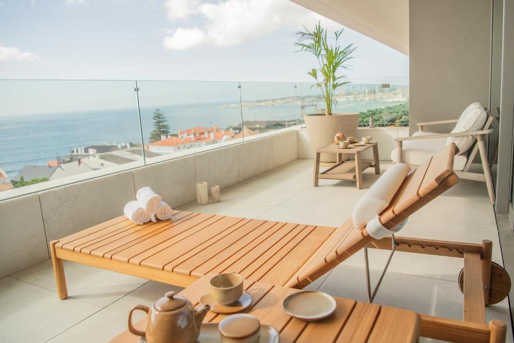 a balcony with a table and a view of the ocean at EVOLUTION Cascais-Estoril Hotel in Estoril