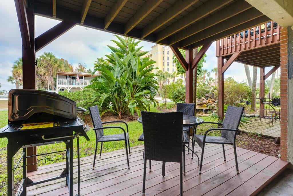 a patio with a grill and chairs and a table at Be A Nomad Beachside Apartments in Jacksonville Beach