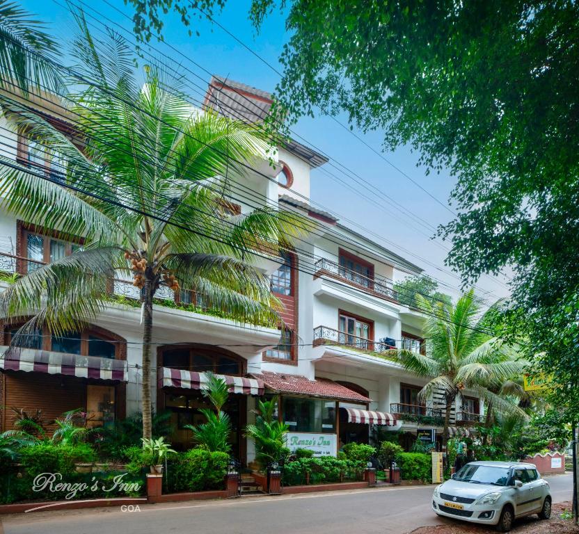 a car parked in front of a building at Renzo's Inn in Calangute