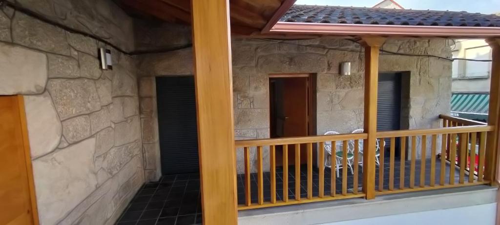 a balcony of a house with a wooden railing at Casa do Corredor in Chantada