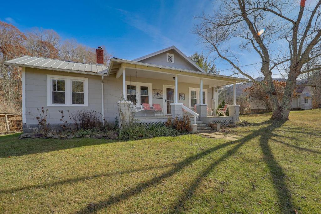 a white house with a tree in the yard at Idyllic Blue Ridge Mountain Home on 26-Acre Farm in Roan Mountain