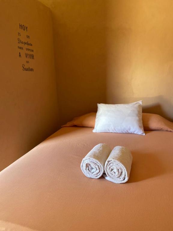 Postel nebo postele na pokoji v ubytování Casa Lol-cab Hostal