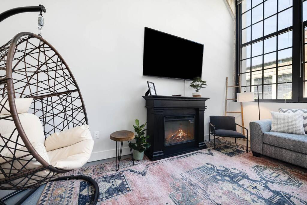a living room with a fireplace and a tv at Peters Cartridge Factory in Maineville
