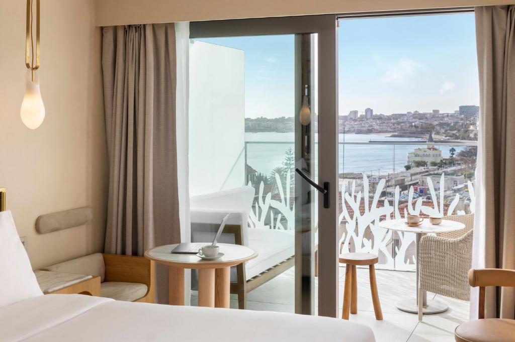 a hotel room with a view of the ocean at EVOLUTION Cascais-Estoril Hotel in Estoril