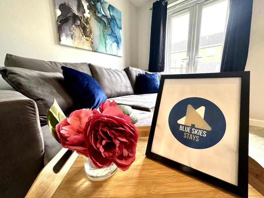 a living room with a vase with a flower on a table at Riverside View by Blue Skies Stays in Middlesbrough