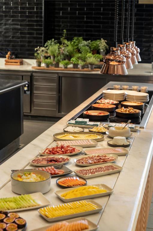 a buffet line with many different types of food at EVOLUTION Cascais-Estoril Hotel in Estoril