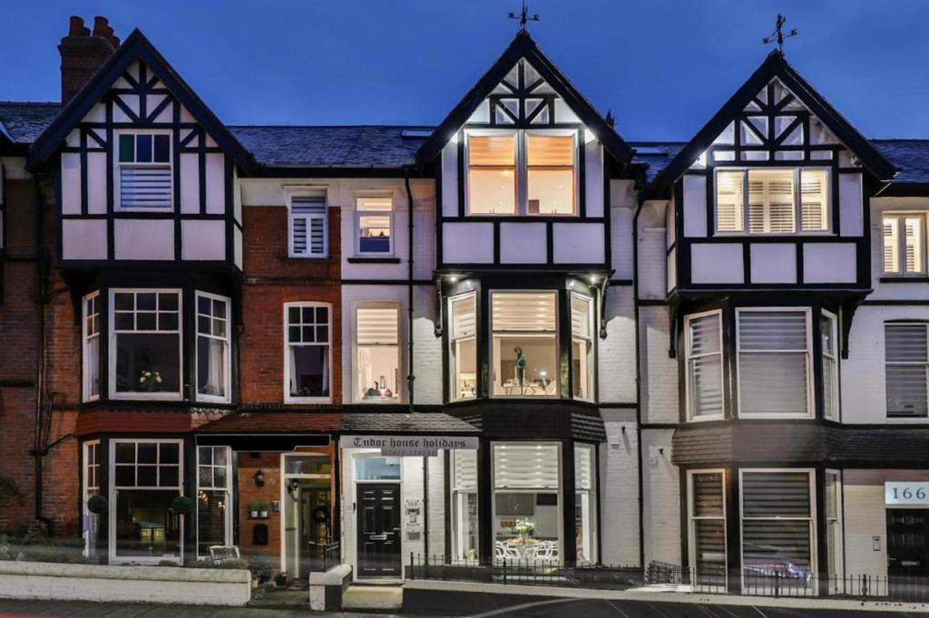 a large black and white building on a street at Tudor House Holidays - The Apartment for 2 people in Scarborough