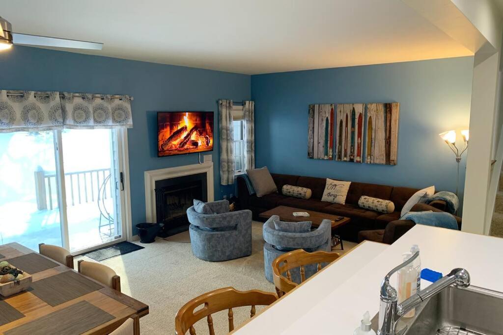 a living room with a couch and a fireplace at Mountainside Condo @ Jiminy Peak in the Berkshires in Hancock