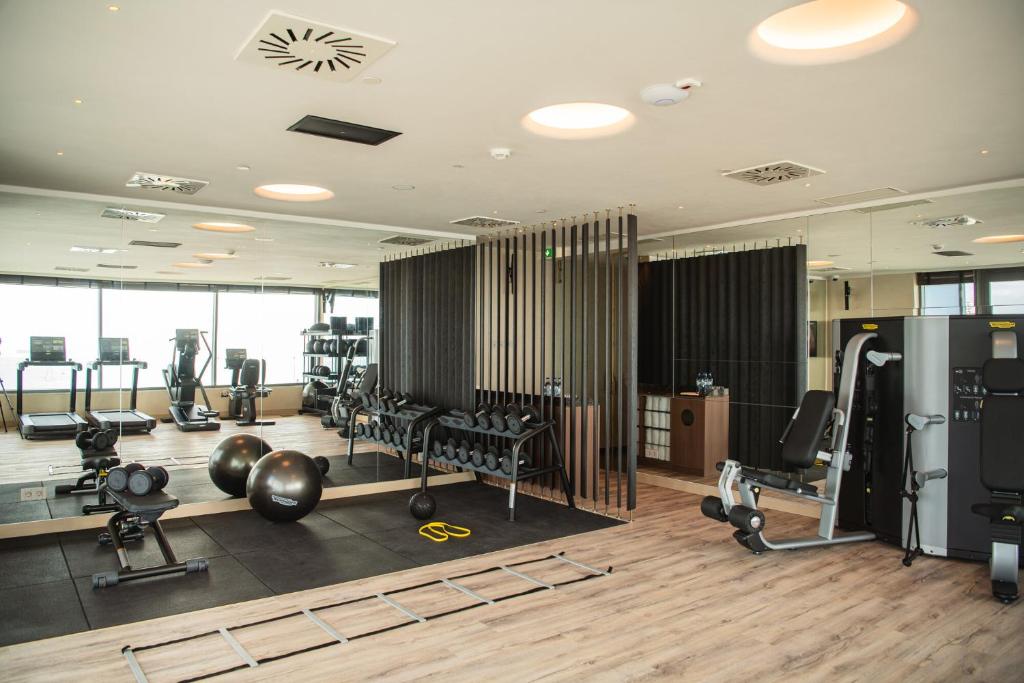 a gym with weights and exercise equipment in a building at EVOLUTION Cascais-Estoril Hotel in Estoril