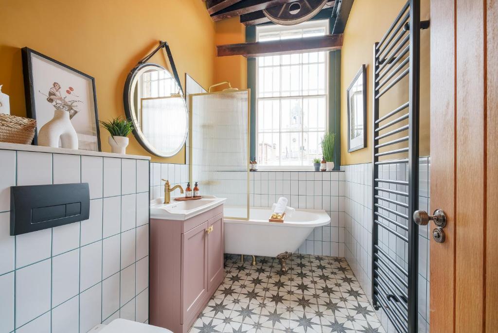 a bathroom with a tub and a toilet and a sink at The Gold Penny - 1 Bed Studio Apartment in Central Bristol by Mint Stays in Bristol
