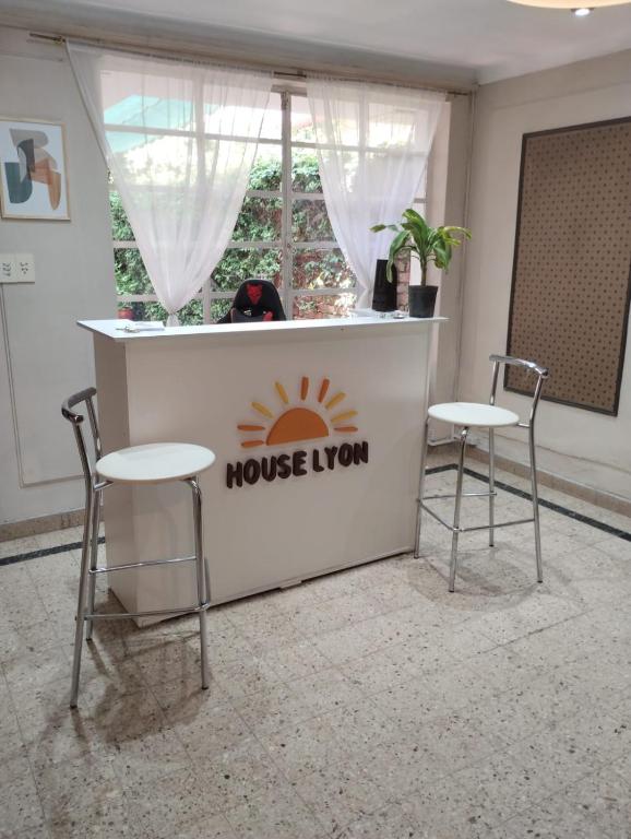 two chairs and a bar with a house lion sign on it at Houselyon in Mendoza